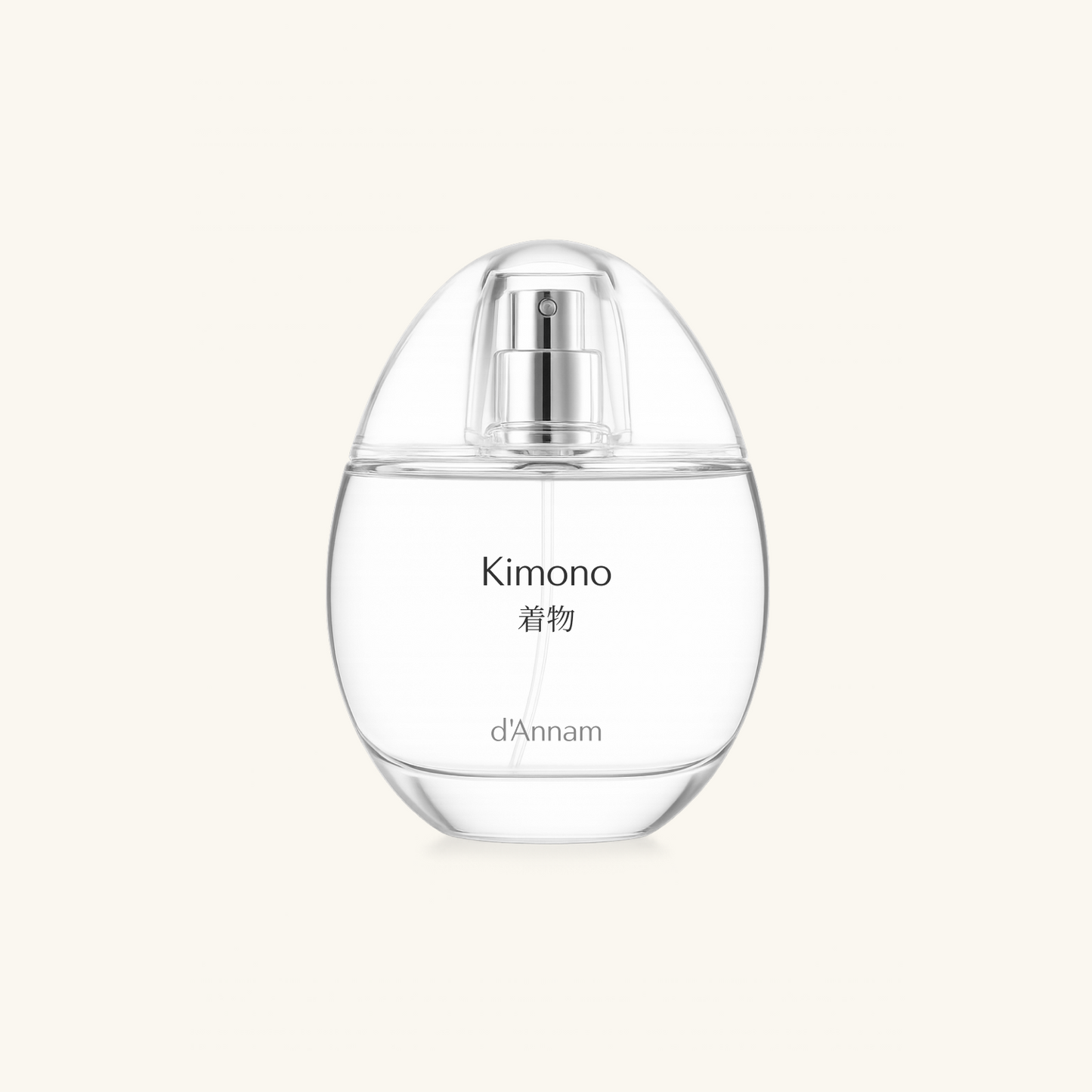 Clear perfume bottle labeled 'Kimono d'Annam' on a light beige background