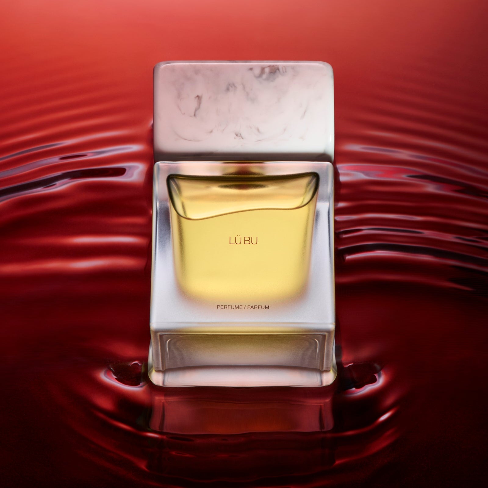 Perfume bottle with packaging on a red water background