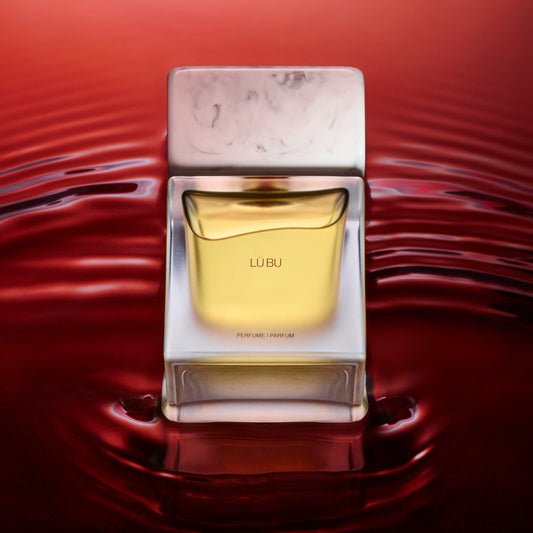 Perfume bottle with packaging on a red water background