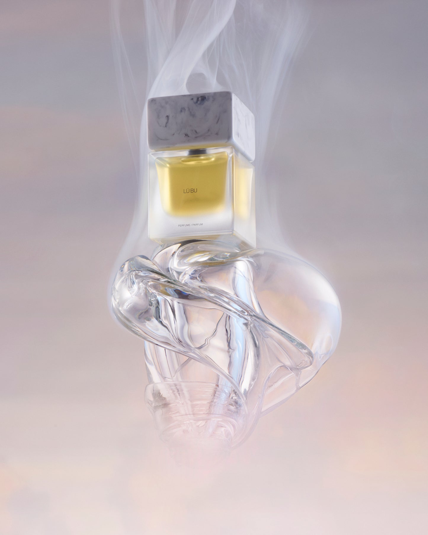 Clear glass bottle with a unique design on a light gray background