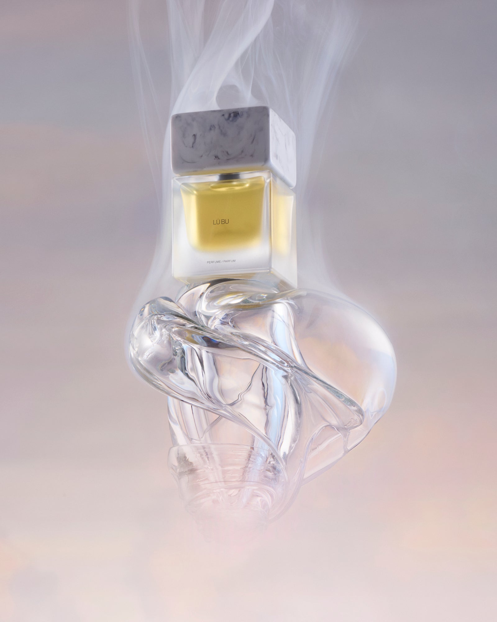 Clear glass bottle with a unique design on a light gray background
