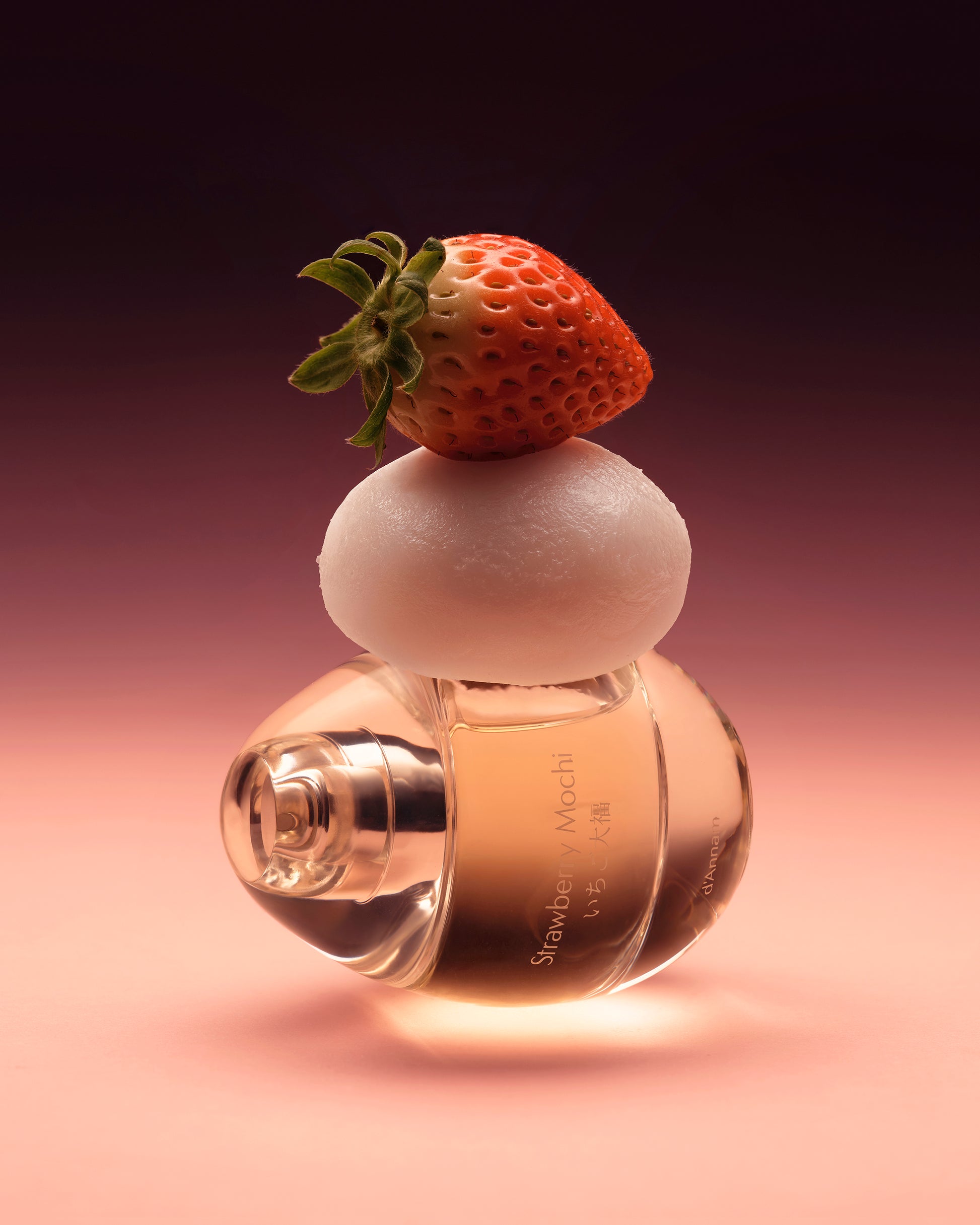 Perfume bottle with a strawberry on top against a gradient background