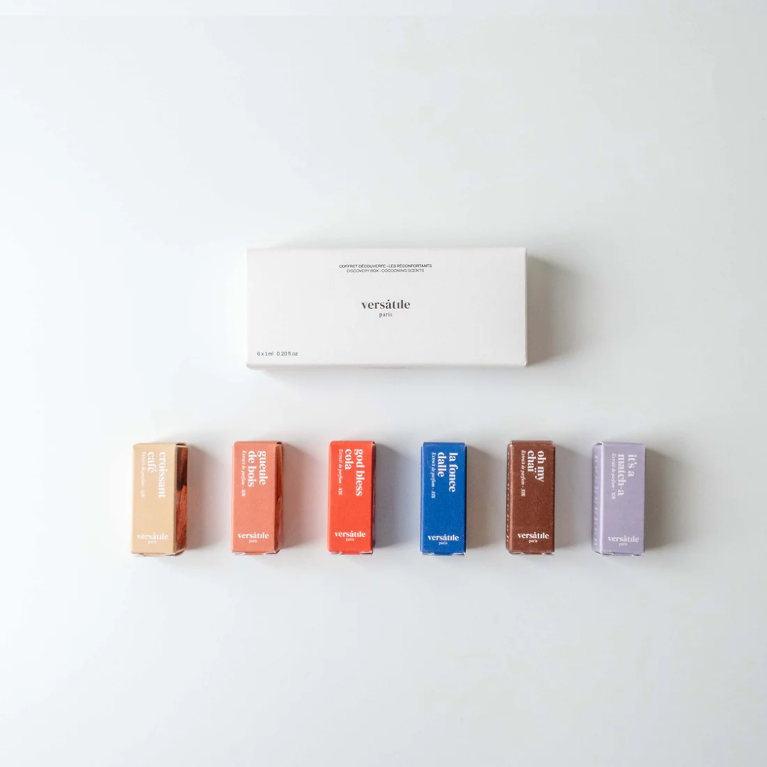 Set of six colorful lip balm containers with a white box labeled 'versatile' on a light gray background.
