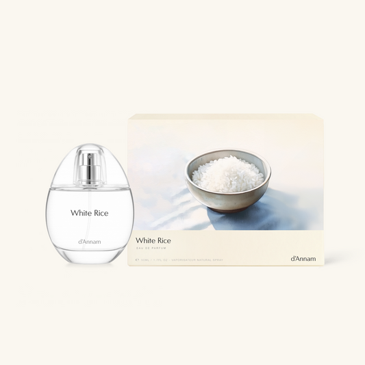 Perfume bottle labeled 'White Rice' by d'Annam with a bowl of rice on a light background