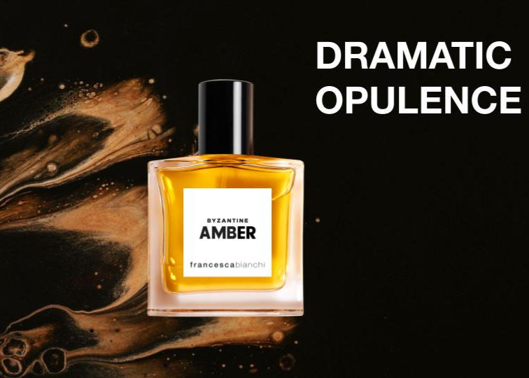 Perfume bottle labeled 'Amber' with artistic background and text 'Dramatic Opulence'.