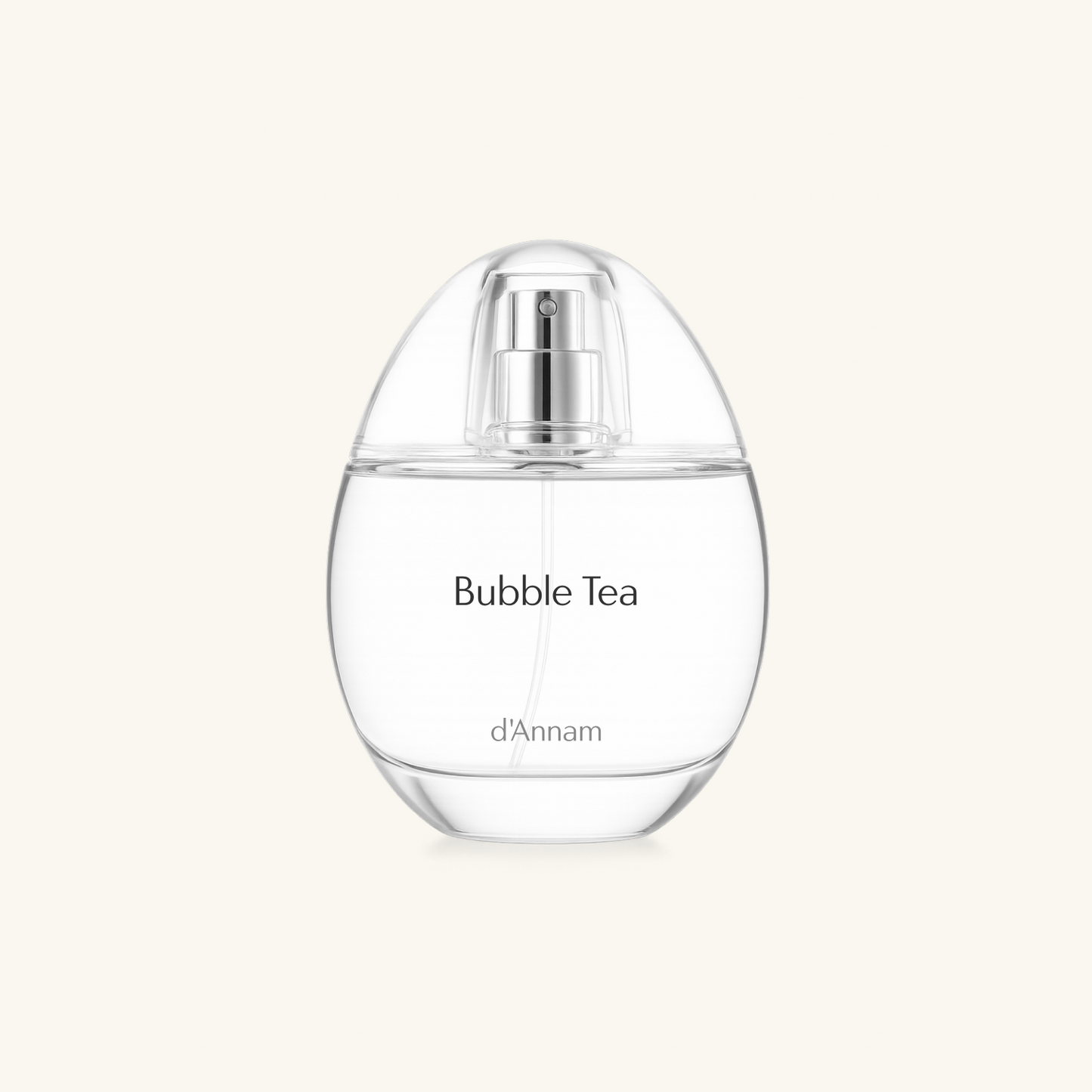 A clear glass perfume bottle labeled 'Bubble Tea' by d'Annam, featuring a silver spray mechanism and a rounded, egg-shaped silhouette, set against a solid off-white background.