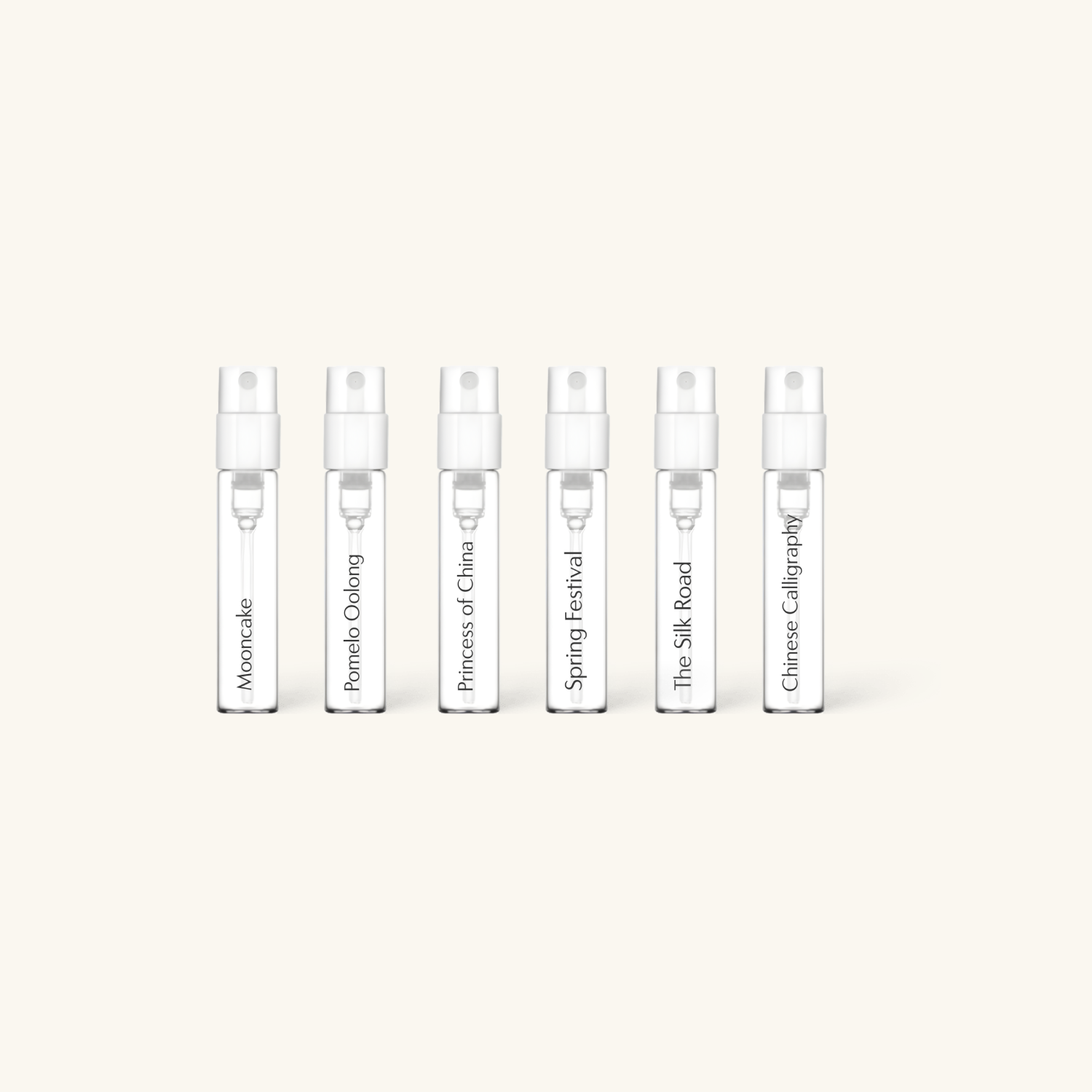 Set of five small perfume bottles with labels on a white background