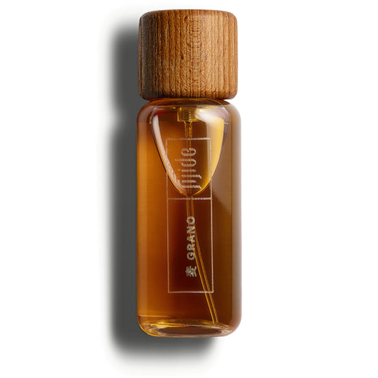 Bottle of Grano with wooden cap on a white background