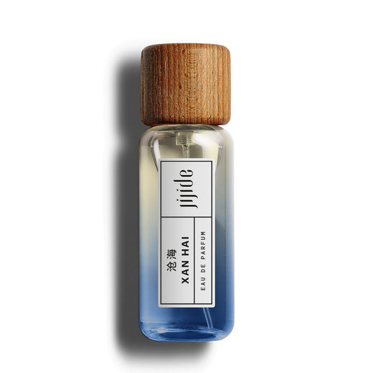 Small glass bottle with wooden cap on a white background
