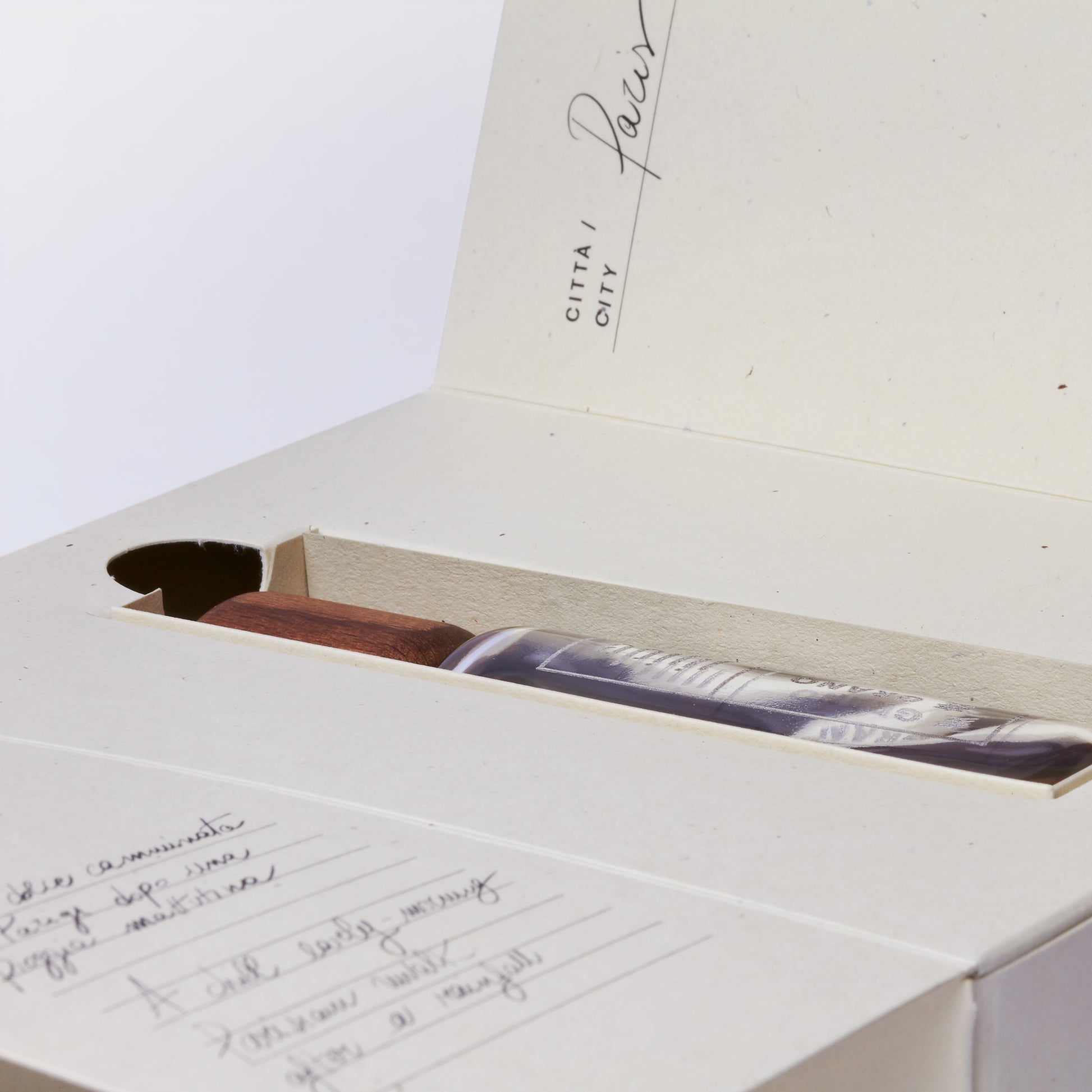 Open box with a photo and handwritten text on a white background