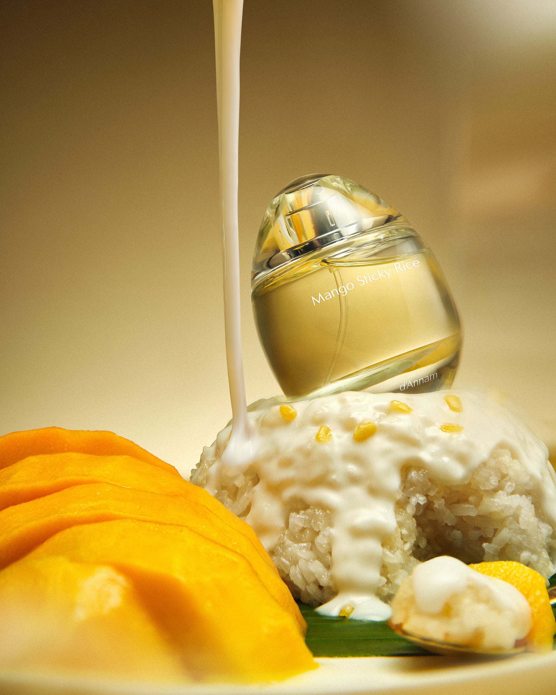 Perfume bottle with a scoop of ice cream and mangoes on a beige background