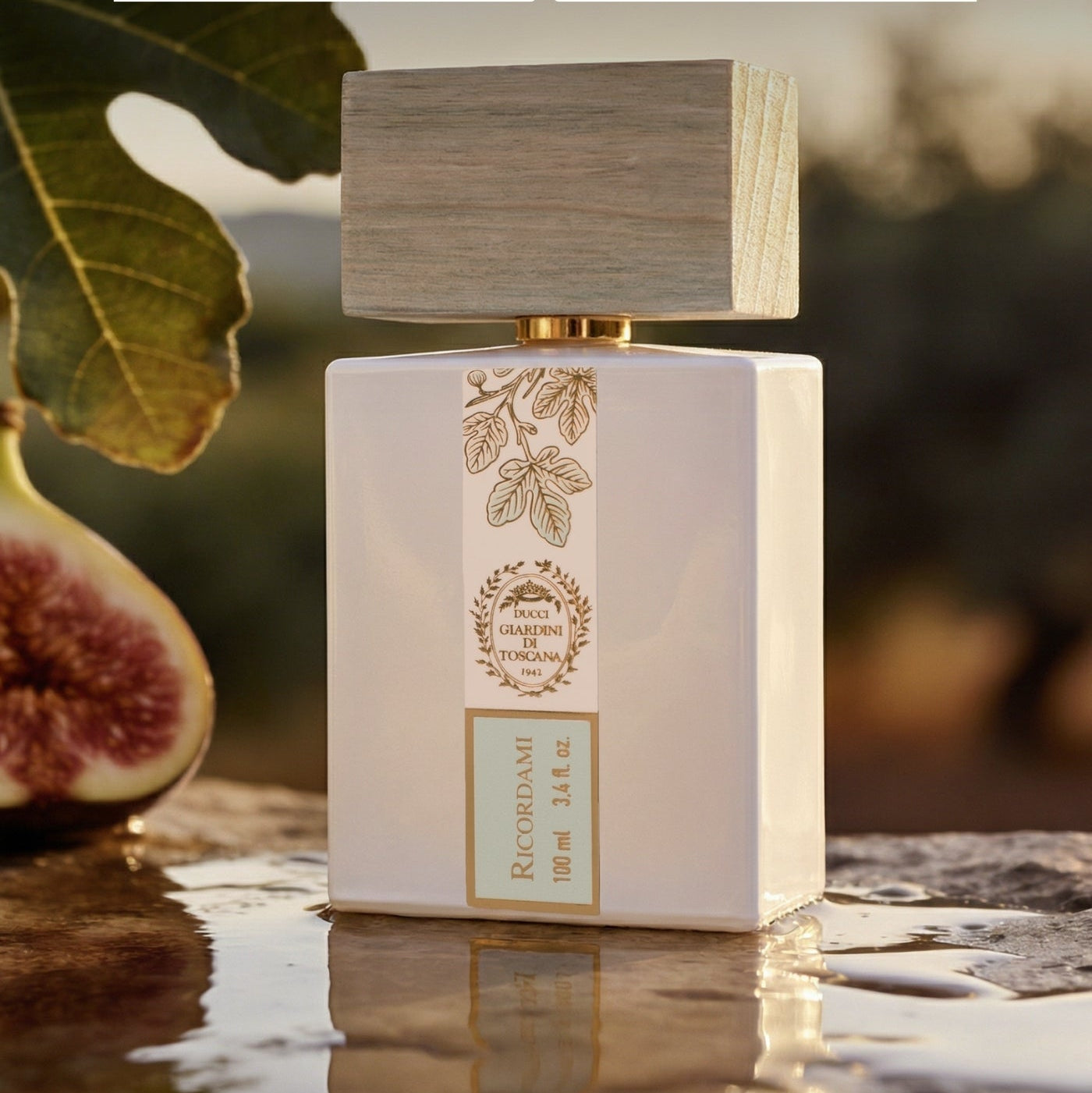 Perfume bottle with 'Giardini di Toscana' branding on a natural background with leaves and figs.